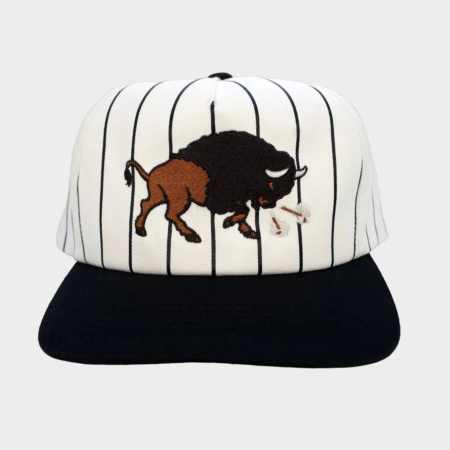 Baseball cap with striped pattern and bison design on a white background