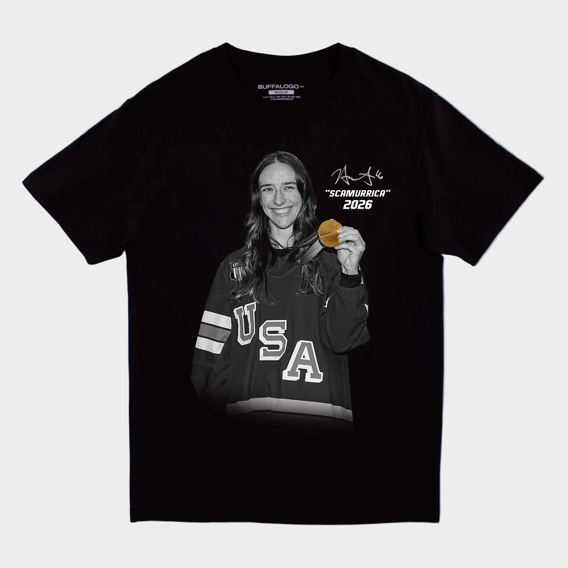 Black t-shirt with graphic of a person holding a medal and 'USA' text, on a light gray background.